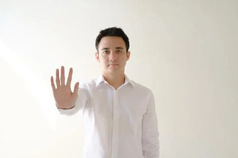 Young Asian man posing stop to the camera Stock Photos
