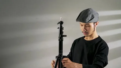 A young asian man preparing a camera tripod Video stock 156028509