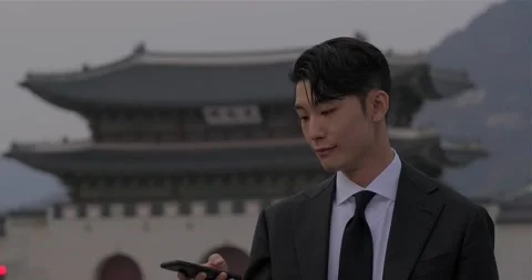 Young asian man pull out his phone and scroll through the notifications on Stock Footage 166875847
