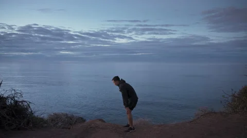 Young asian man runner finish run at sunrise Stock Footage 203836068