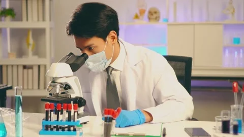 Young Asian man scientist adjust focus and use Microscope in laboratory 動画素材 131869166