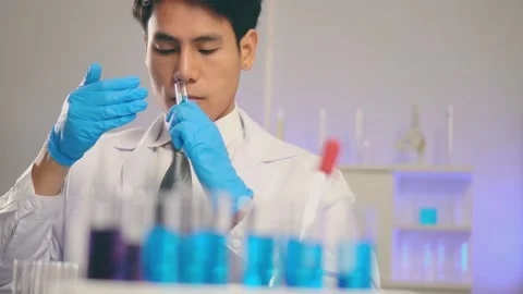 Young Asian man scientist test tubes smell  biochemical in laboratory Stock Footage