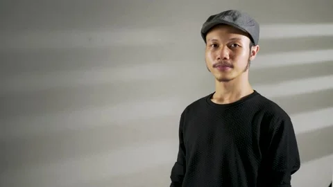 A young asian man showing a cable plug Stock Footage 156018693