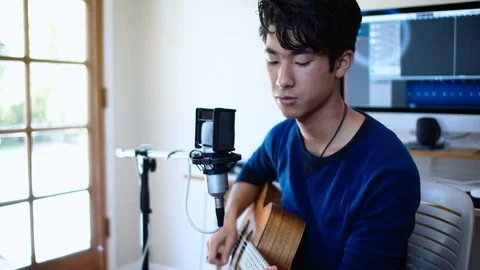 Young Asian Man Singing into Microphone in Home Recording Studio Stock Footage 112639293