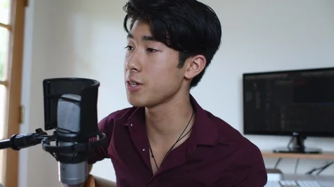 Young Asian Man Singing into Microphone in Home Recording Studio Stock Footage 112685935