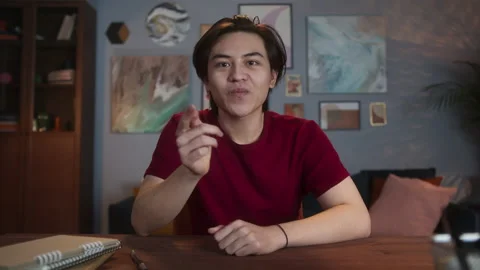 Young asian man smiling while video conference at home during coronavirus Stock Footage 146386899
