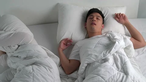 Young Asian man snoring While sleeping in bed. Stock Footage 156639273