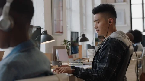 Young asian man software developer using computer designing mobile application Stock Footage 103550141