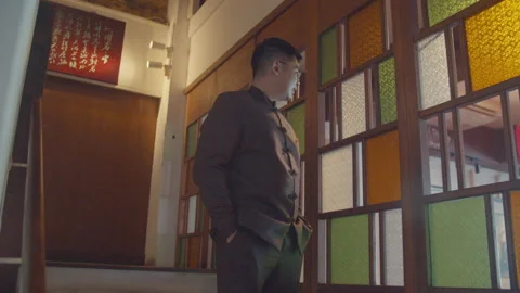 Young Asian Man Standing and Looking At The Window Stock Footage 161570184