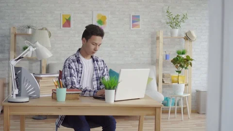 Young asian man student using laptop Stock Footage 111364975