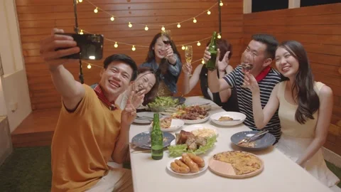 Young asian man taking group photos using smartphone sharing.lifestyle on soc Video stock 219266033