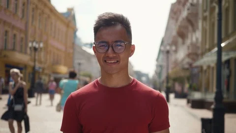 Young Asian man thinking. Portrait of young Asian man thinking outdoor on street Stock-Footage 114816669