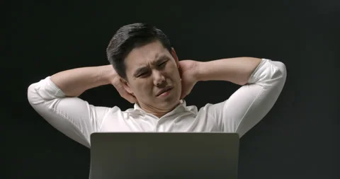 Young asian man is tired while using laptop computer for work or study online. 스톡 동영상 148126775