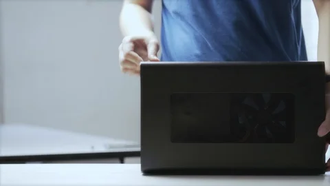 A young Asian man unpack an external GPU device Video stock 129726066