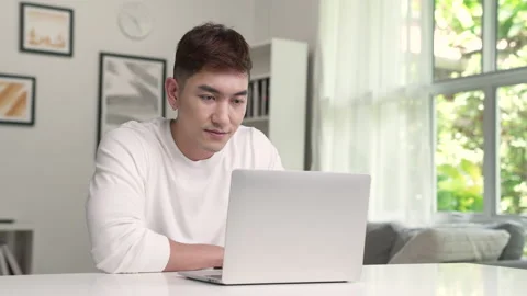 Young Asian man using laptop at home. Stock Footage 218571983