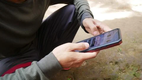 Young asian man using phone and app Instagram Stock Photos
