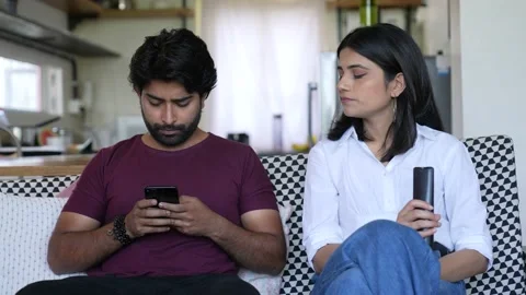 Young Asian Man Using Smart phone do chat and woman looking him while sitting Видео 154546308