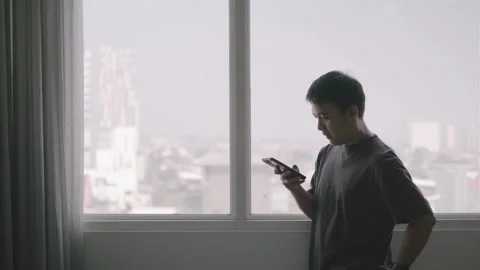 Young Asian Man Using a Smartphone Stock Footage 288061537