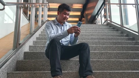 Young asian man using smartphone gadget social media mobile application Stock Footage 296336845