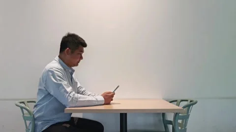 Young asian man using smartphone gadget social media mobile application Stock Footage 296383224