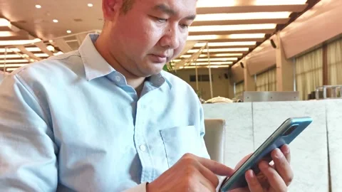 Young asian man using smartphone gadget social media mobile application Stock Footage 296640833