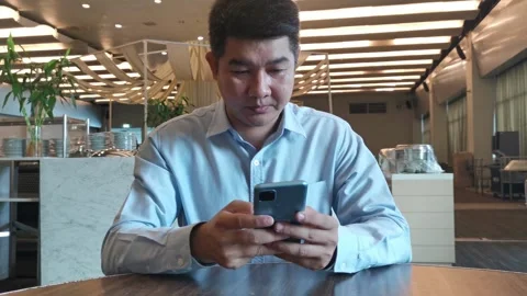 Young asian man using smartphone gadget social media mobile application Stock Footage 296640871