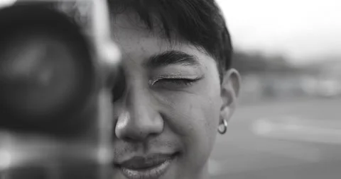 Young asian man using vintage old video camera outdoor Stock Footage 185515013