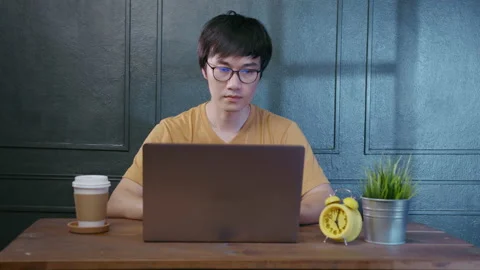A young asian  man is working with laptop computer in home 스톡 동영상 149976719