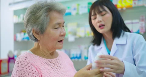 Young Asian pharmacist talking with customer at pharmacy. Stock Footage 252008518
