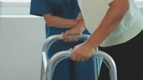 Young asian physical therapist working with senior woman on walking with a .. Stock Footage 240655959