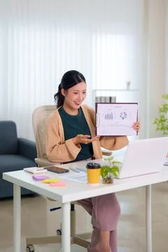 Young Asian professional presenting data analytics report during online vid.. Stock Photos