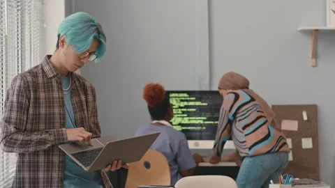 Young Asian Programmer Using Laptop in Office Stock Footage 241271733