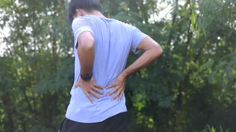 Young Asian runner sustains a back pain injury, Sport injury, Man with back pain Stock Footage 138808934
