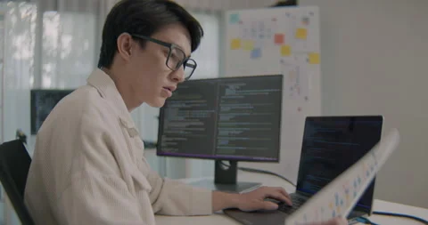 Young Asian Software Developer Reviewing Project Documents In Modern Office. Video stock 308162294