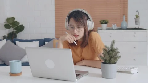 Young asian studen using laptop computer learning Online Course on internet Video stock 128189093