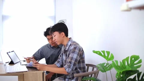 Young asian Student collaborating on project sharing ideas used tablet in home Stock Footage 318513247