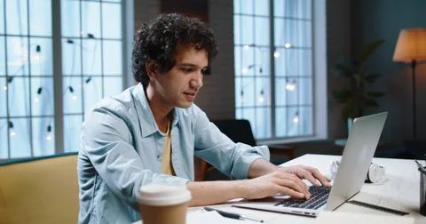 Young asian student doing an assignment research on his computer. Manager Stock Photos
