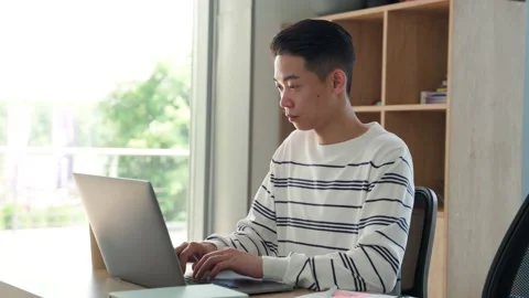 Young asian student sitting using pc laptop computer at modern college campus. Stock Footage 157069841