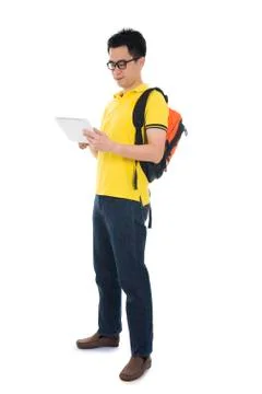 Young asian student using pad pc isolated on white background. Stock Photos