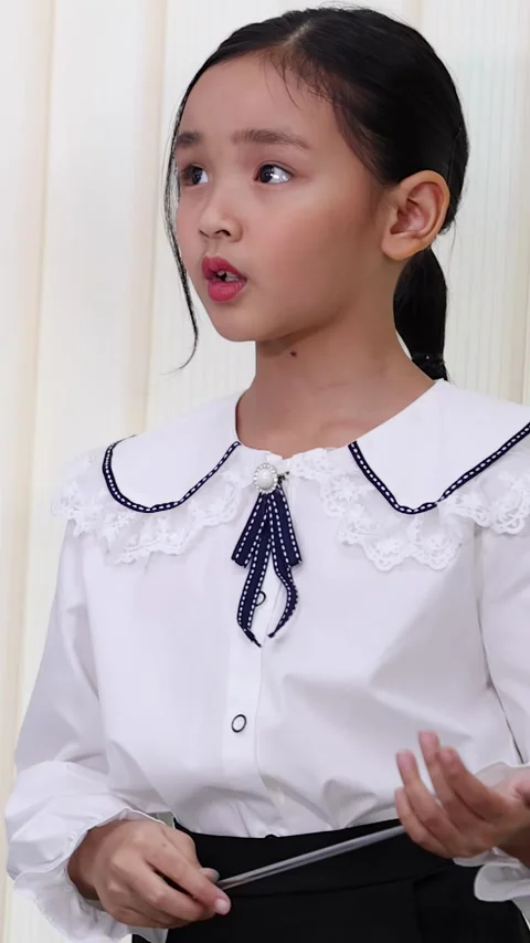 Young Asian Student in White Blouse Raising Hand in Classroom Stock Footage 335124673