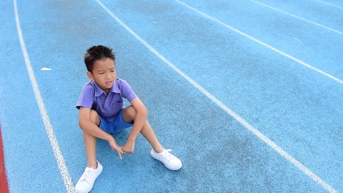 Young Asian Thai boy drinking water from bottle during resting  Stock Footage 79008368