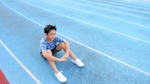 Young Asian Thai boy drinking water from bottle during resting  Stock Footage 79008380