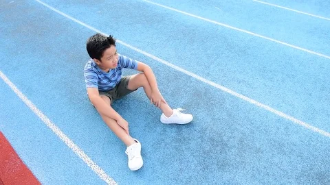 Young Asian Thai boy drinking water from bottle during resting  스톡 동영상 79008388