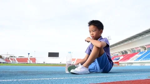 Young Asian Thai boy drinking water from bottle during resting 스톡 동영상 79008440