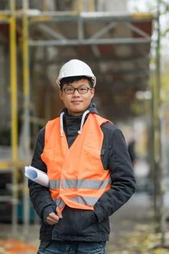 Young Asian trainee engineer at work on construction site Stock Photos