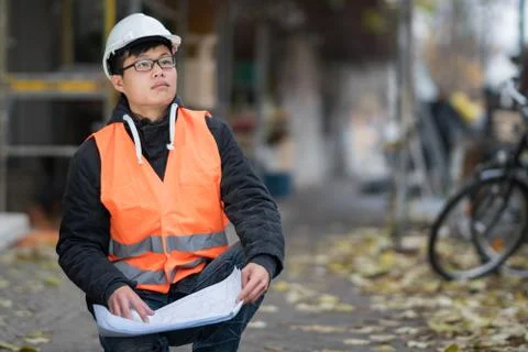 Young Asian trainee engineer at work on construction site Stock Photos