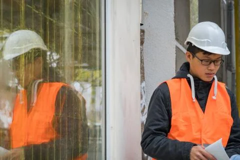Young Asian trainee engineer at work on construction site Stock Photos