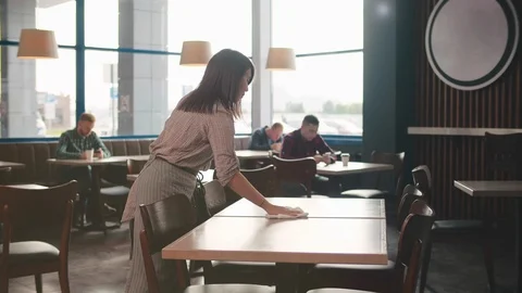 Young asian waitress cleaning table in restaurant. Cafe staff cleaning furniture 스톡 동영상 123474544