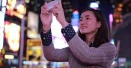 Young Asian Woman In City At Night Taking A Selfie Photo Picture 4K Stock Footage