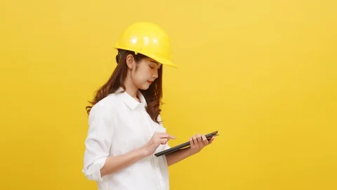 Young Asian woman engineer using digital tablet with positive expression. Stock Footage 129185548
